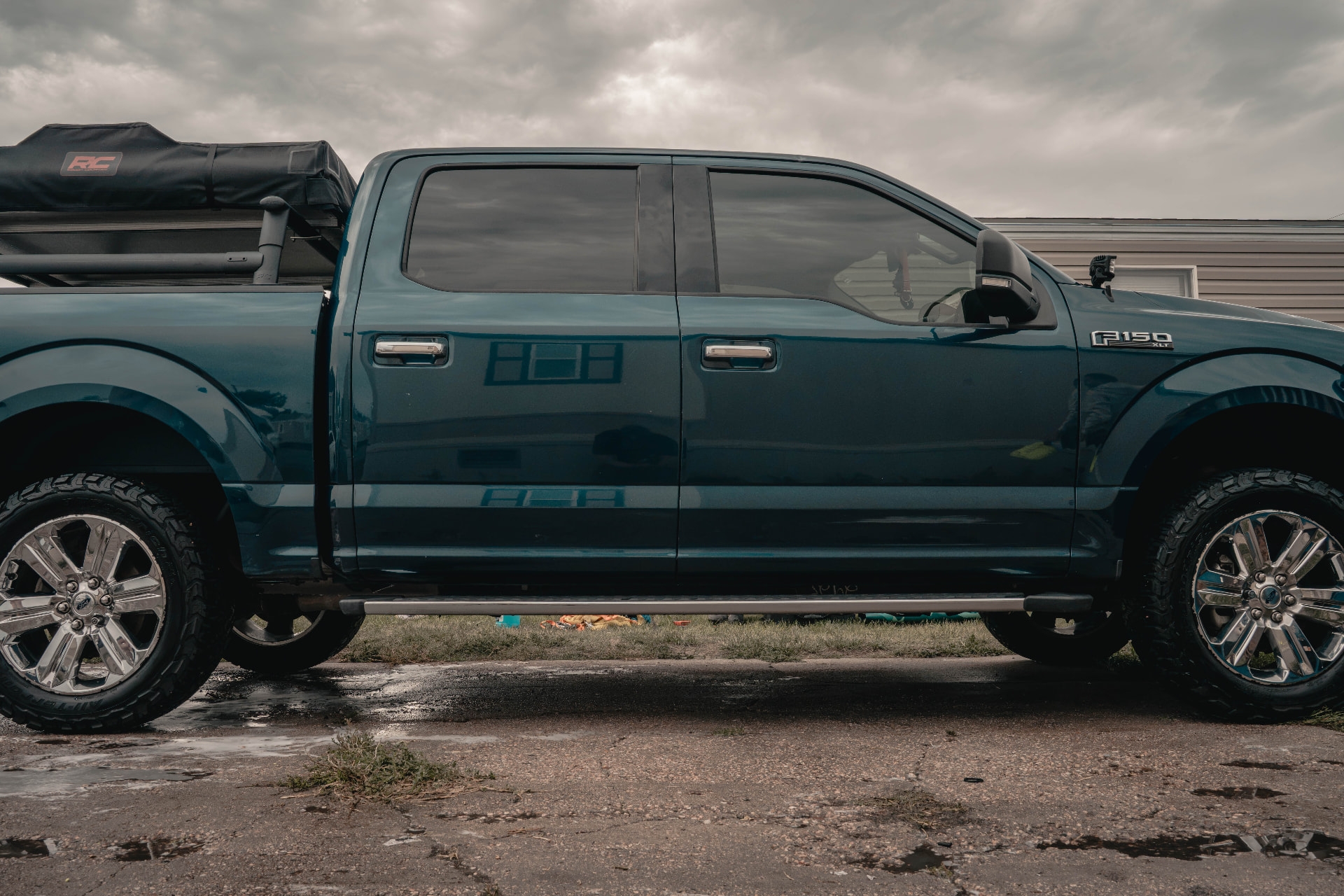Glossy blue Ford F-150 XLT side profile after a full exterior detail