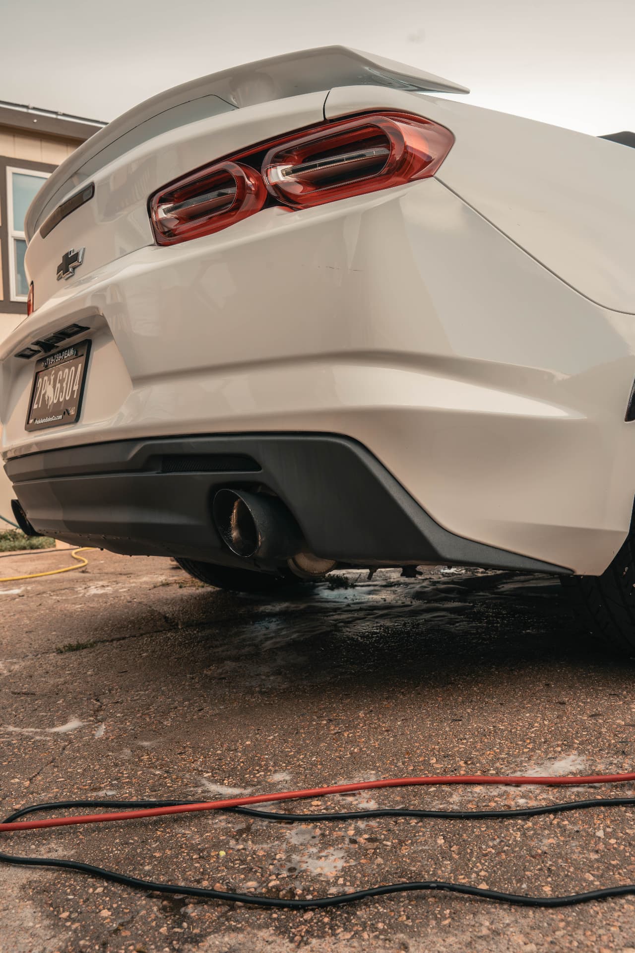 Polished rear end of a white Camaro after an exterior detail